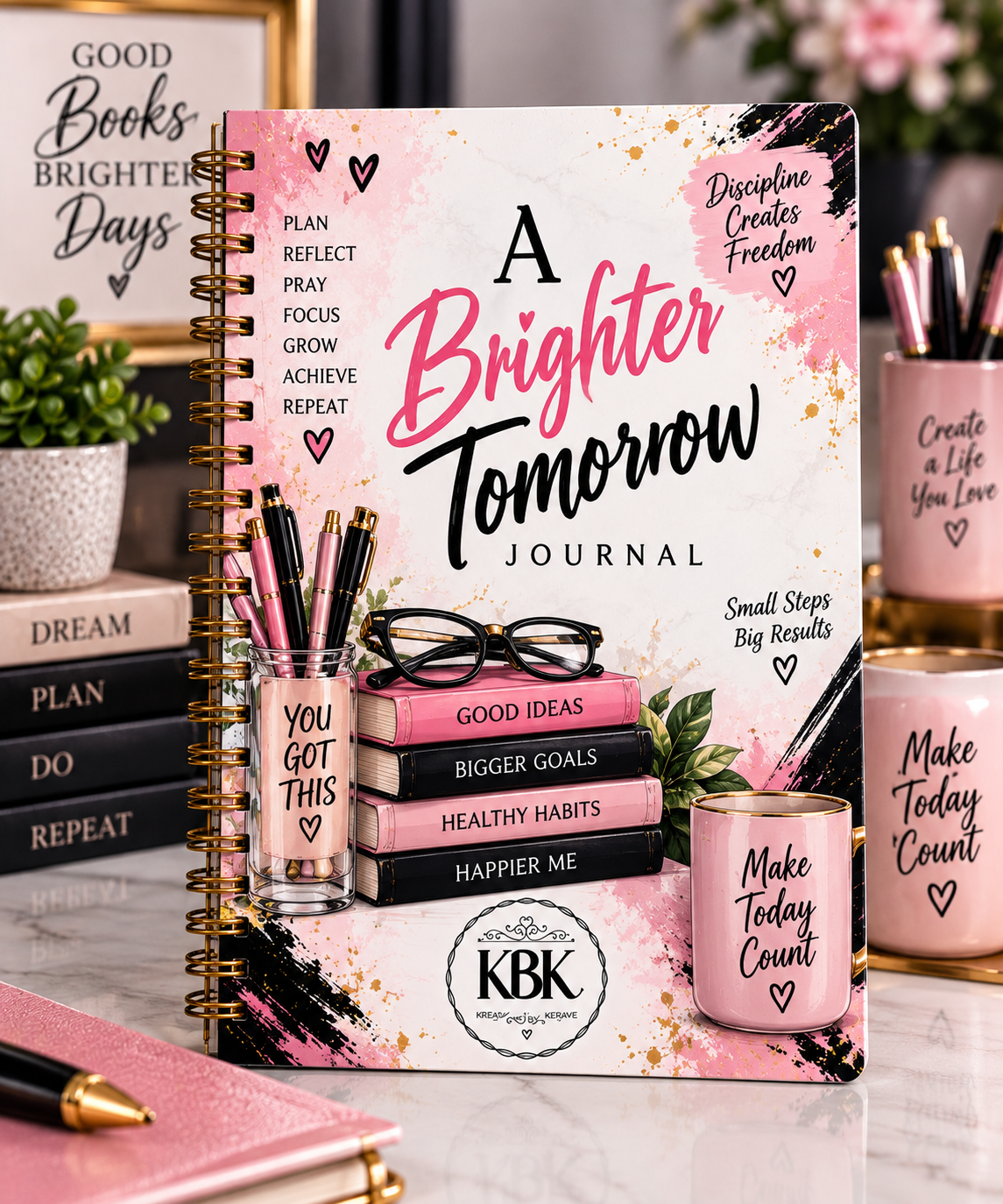 A Brighter Tomorrow spiral-bound journal in pink and black on a marble desk