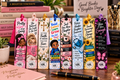 Eight colorful inspirational bookmarks with tassels displayed against stacked books